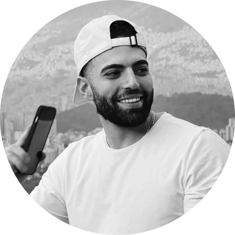 Iman Manafi smiling, city skyline behind him
